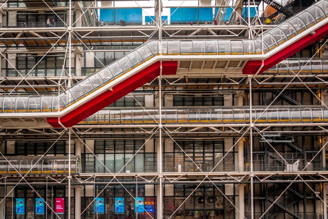 View of the Centre Pompidou from a lower angle, emphasizing its height and industrial aesthetic against the sky.
