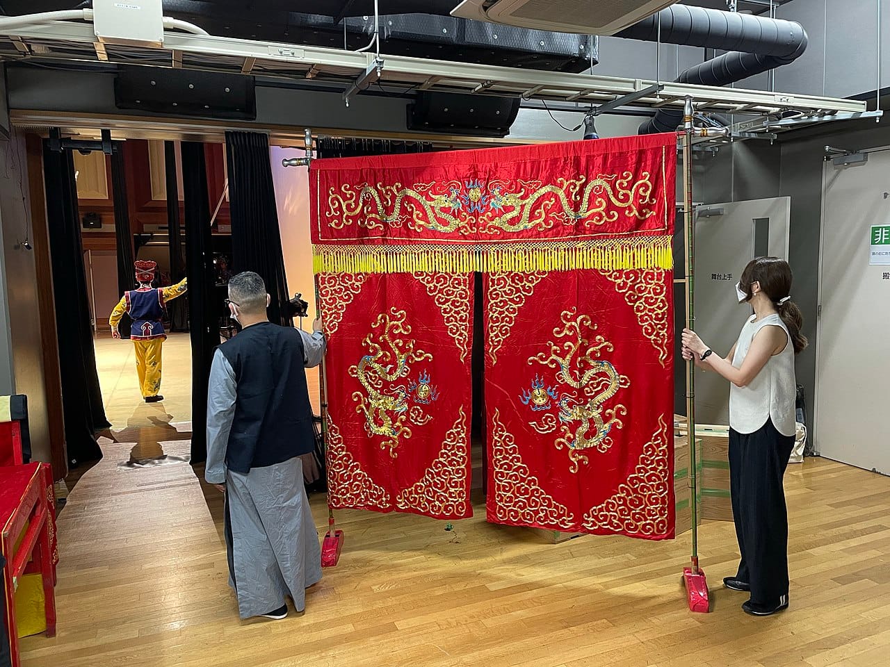 A vibrant red velvet theater curtain draped elegantly across a stage.