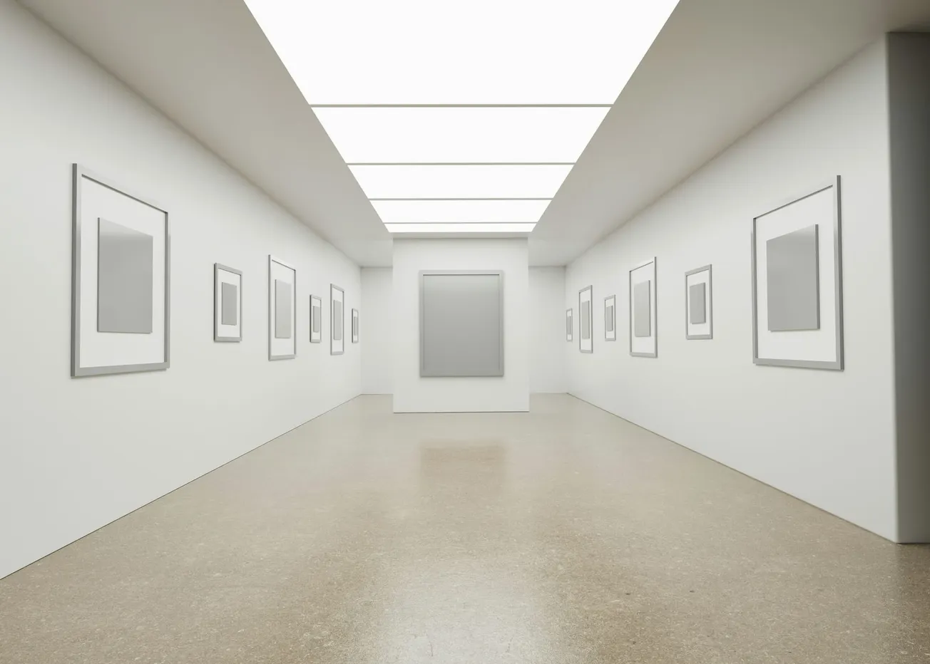 A pristine white gallery interior with empty frames on white walls, polished floors, and clinical overhead lighting