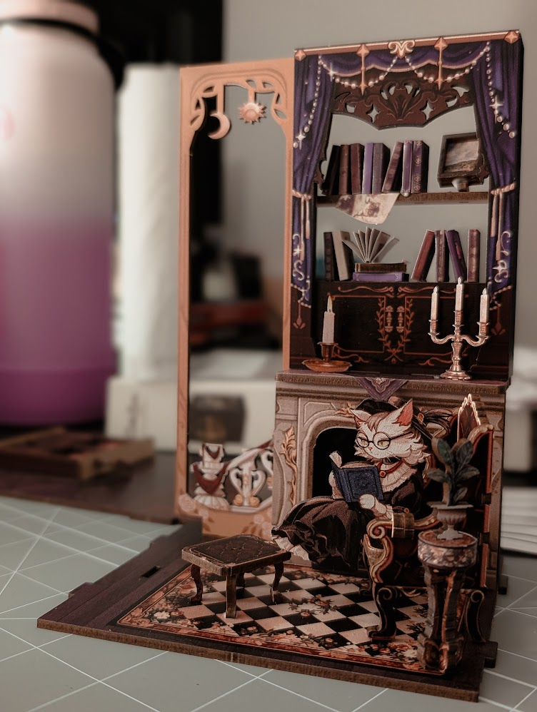 An in-progress photo of one of the book nooks, a cat-themed study.