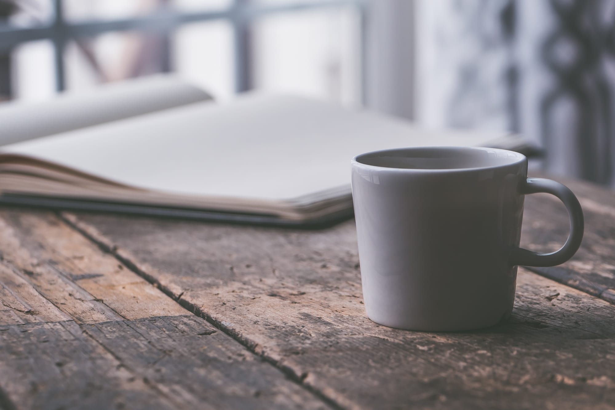Journal and mug on wooden table