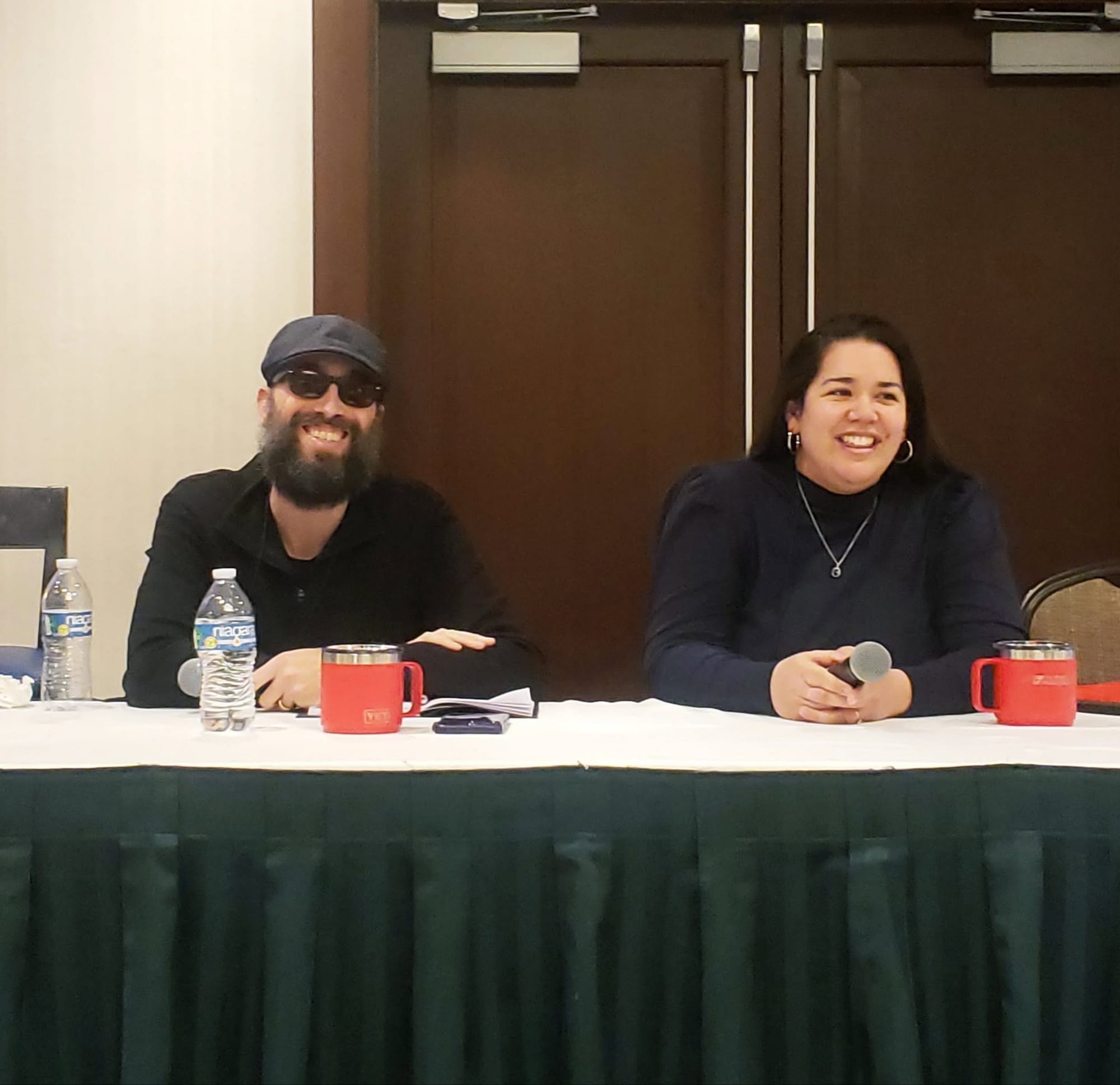 Monica and Russell speaking at a writing conference