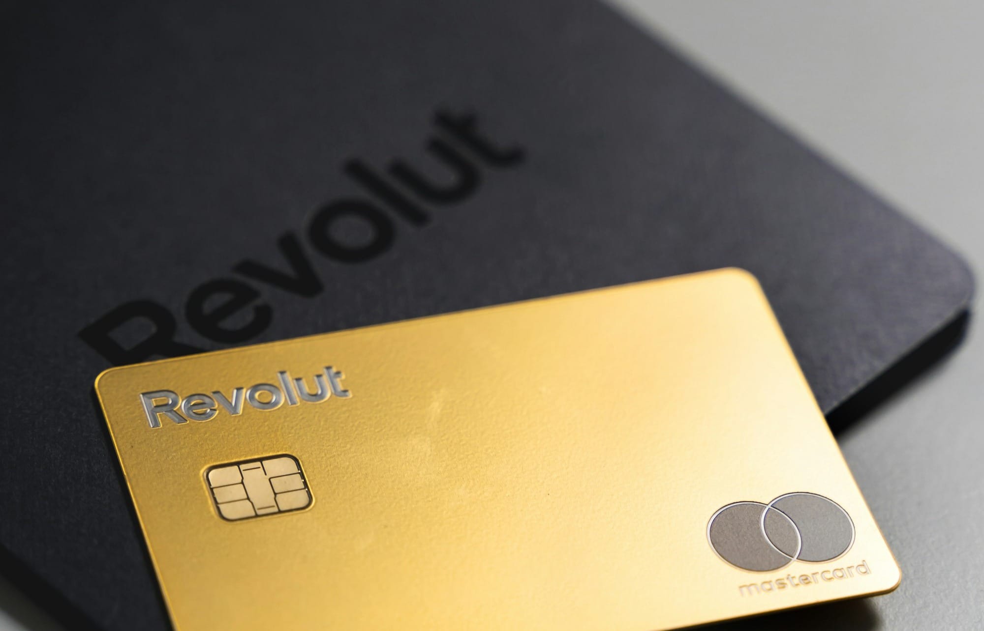a black and gold credit card sitting on top of a table
