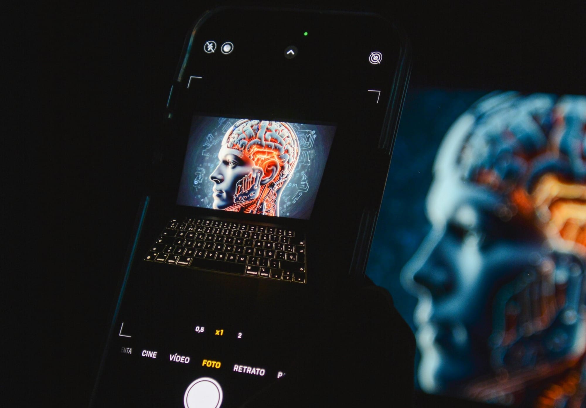 a cell phone sitting on top of a laptop computer