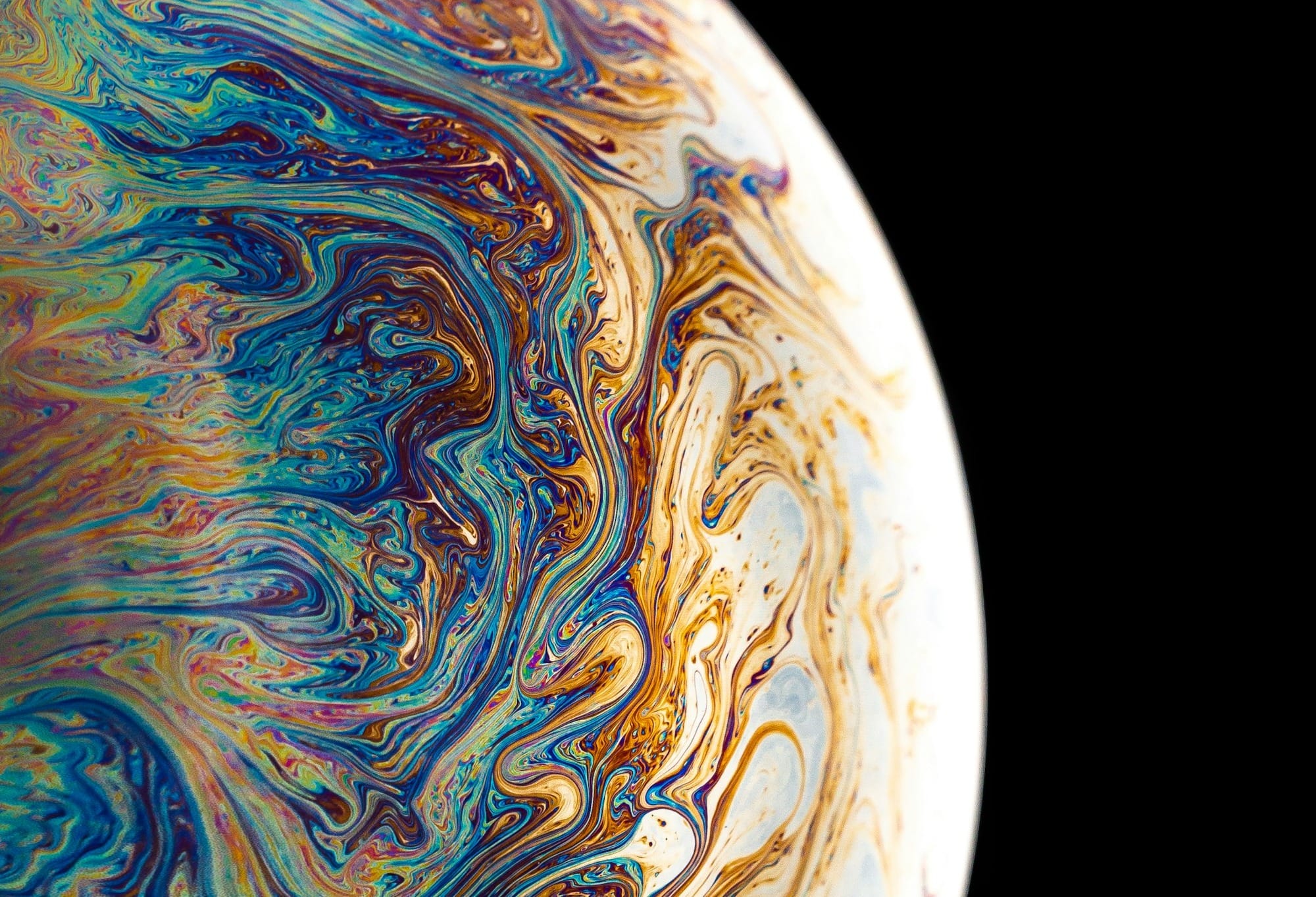 blue, yellow, and brown planet with black background