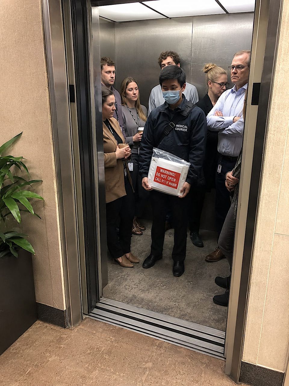 The elevator was full, but mostly with tension.
