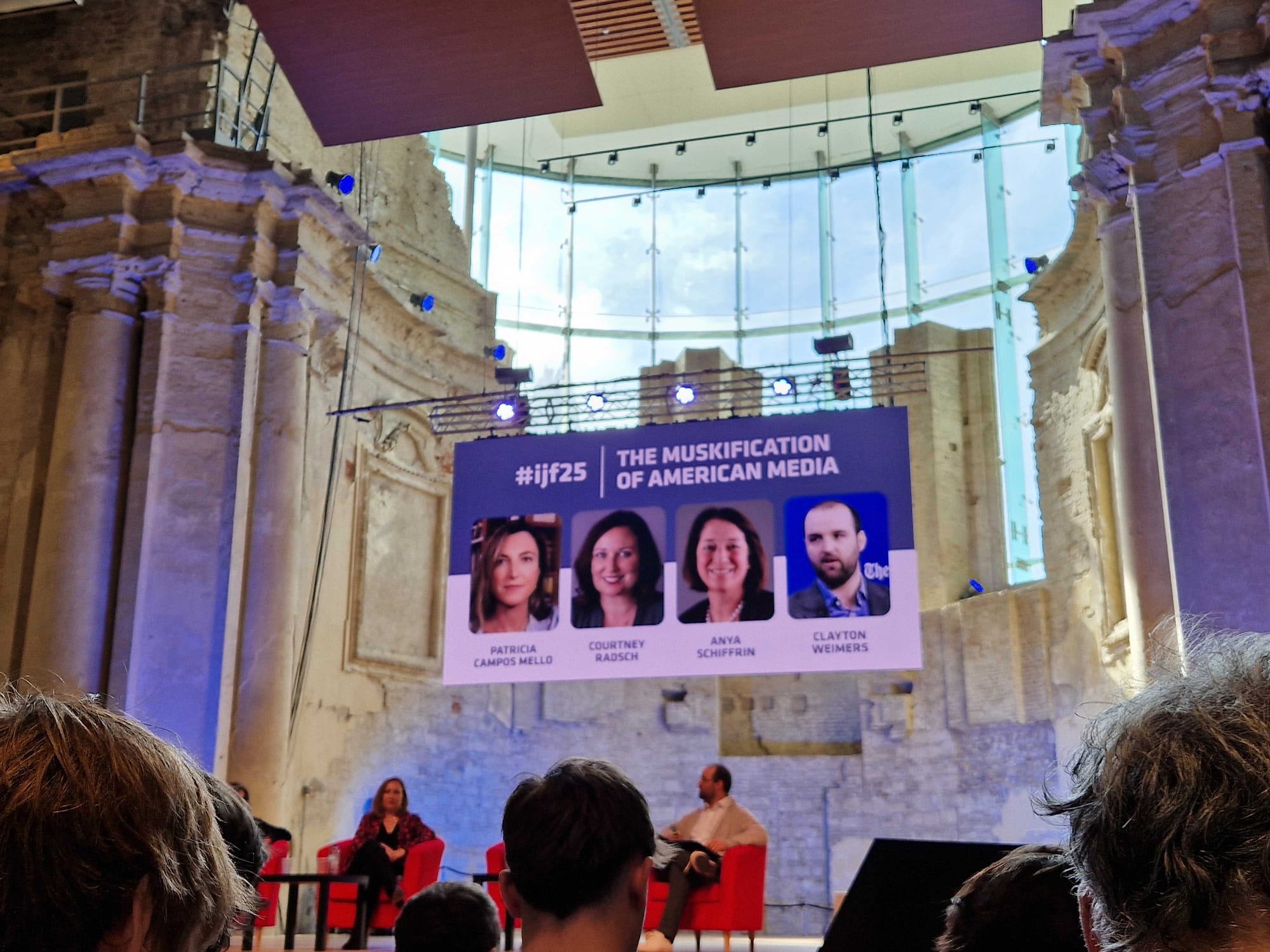 In an old church, a screen shows details on the panel: The Muskification of American Media