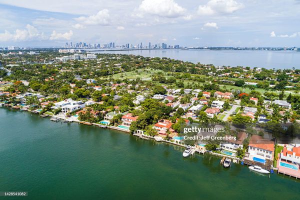 Miami Beach, Florida, aerial view, Indian Creek La Gorce Island Country Club, waterfront mansions estates homes and city skyline.
