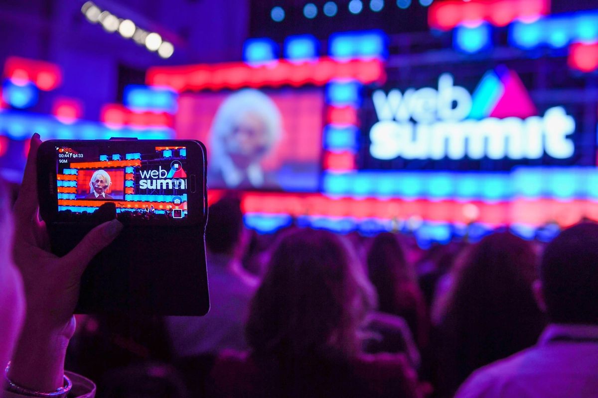 Escenario principal de Web Summit en el Altice Arena de Lisboa, con público y pantallas iluminadas.