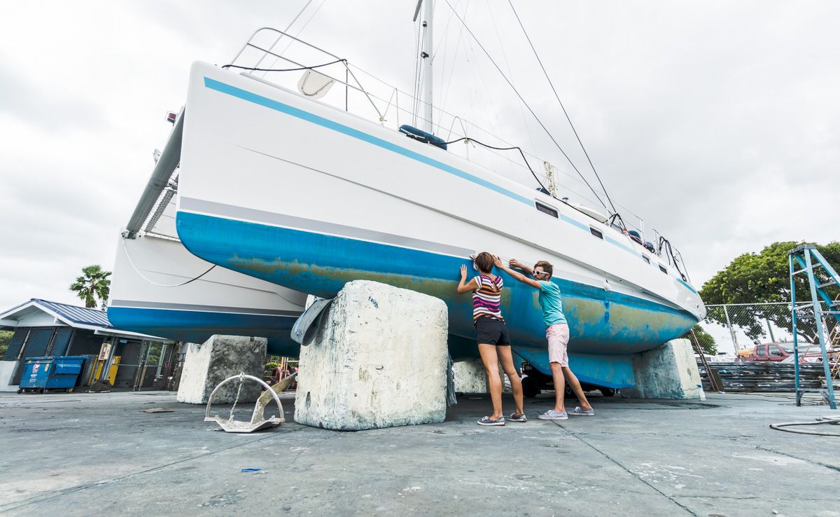 Applying hull strips to sailboat