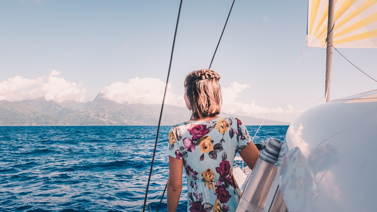 nikki wynn spotting tahiti off in the distance while sailing the south pacific