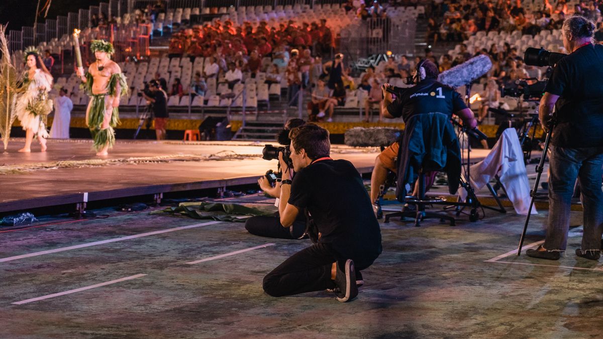 Jason Wynn on the media floor filming tahitian dancers