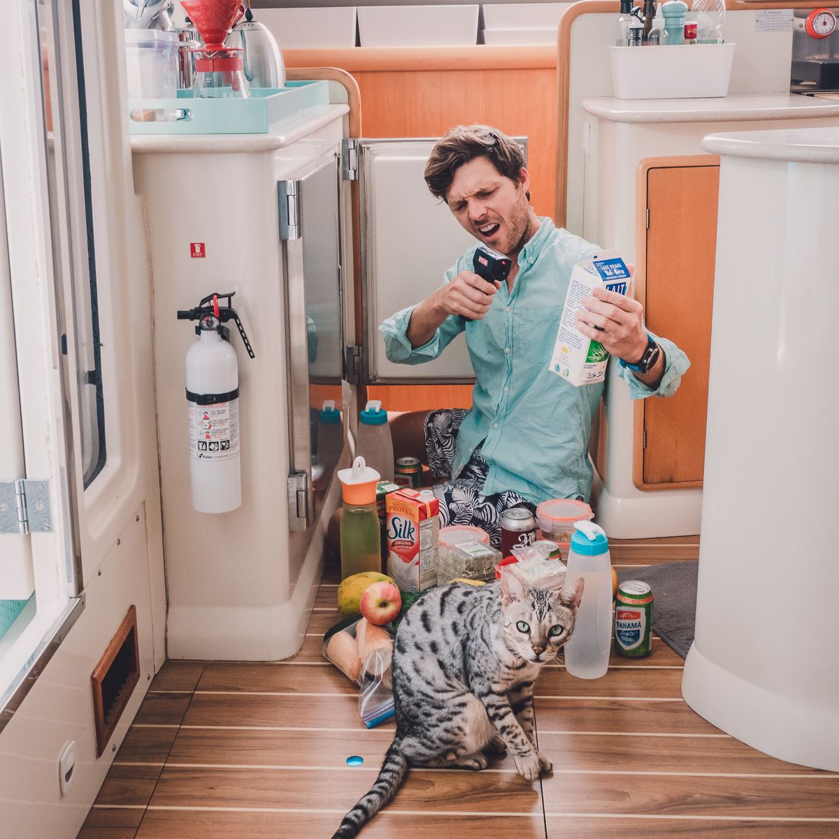 jason wynn showing temp gun and broken sailboat fridge