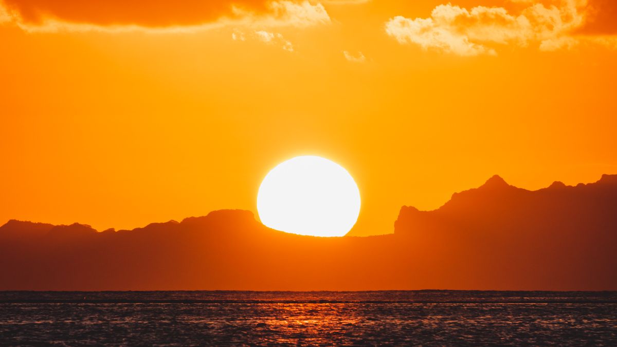 stunning sunset from sailboat in huahine french polynesia
