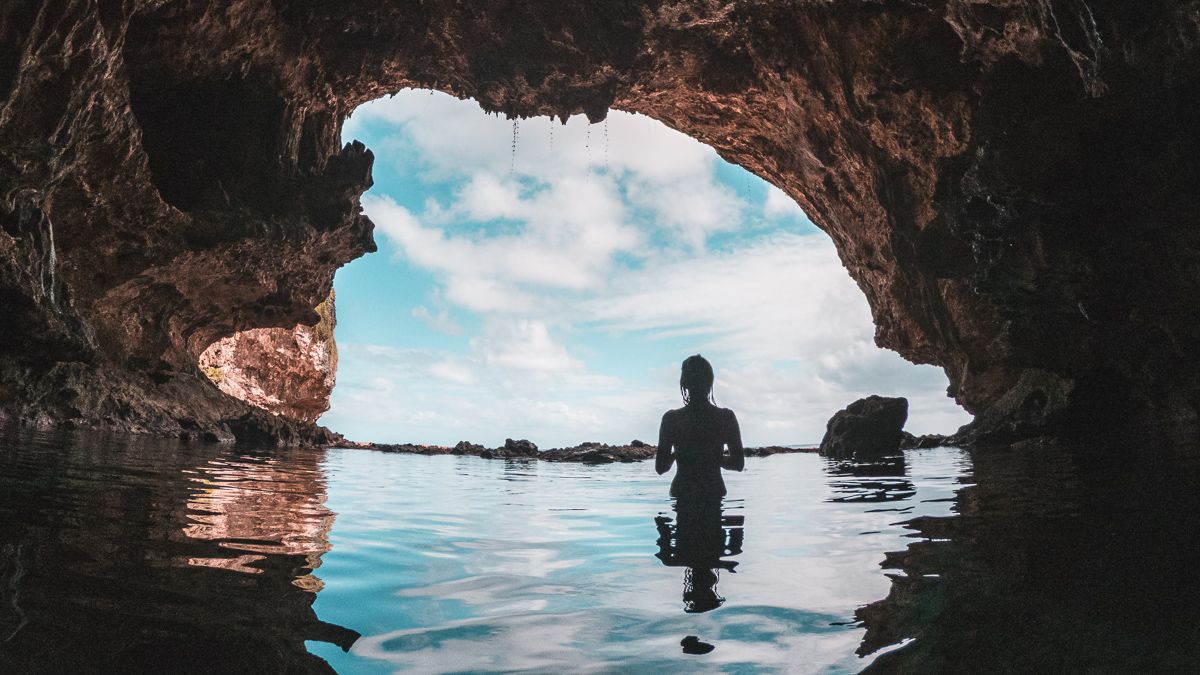 nikki wynn swimming in a cave in niue in the south pacific