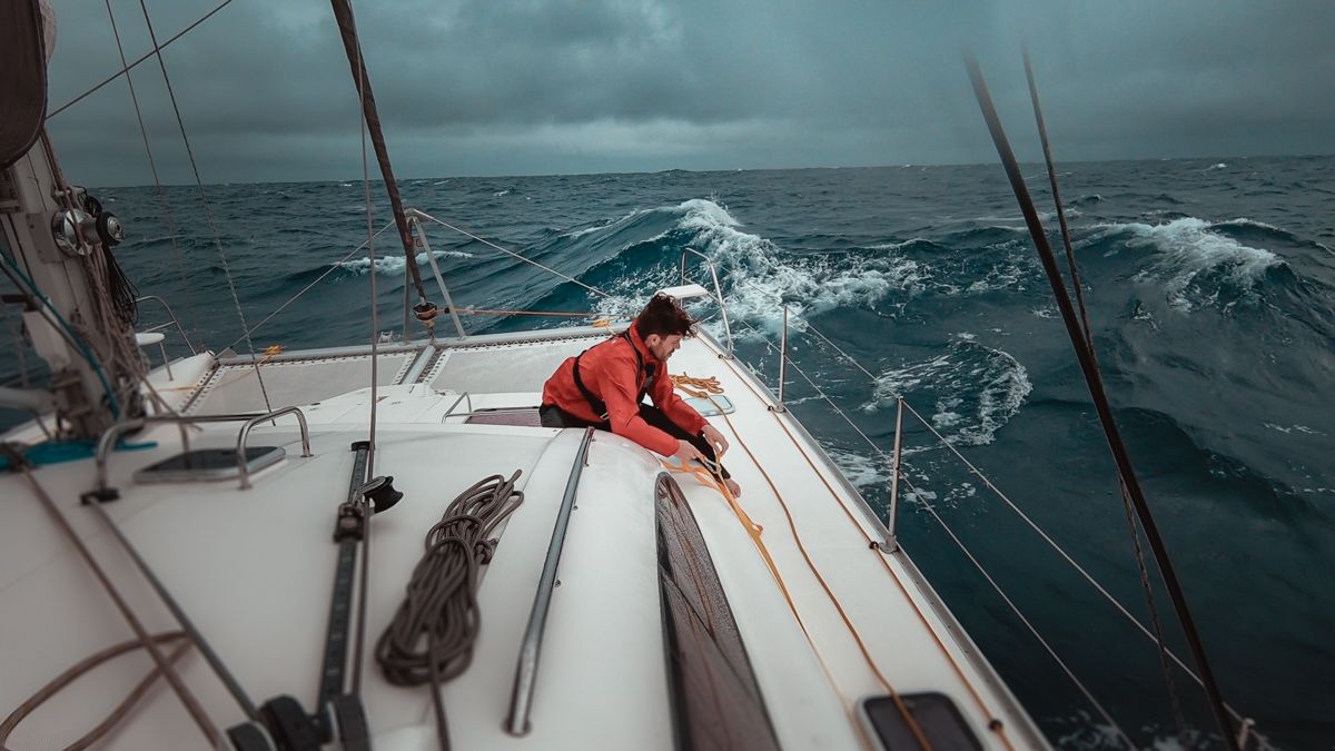 Jason Wynn battling waves in the south pacific aboard sailing catamaran curiosity