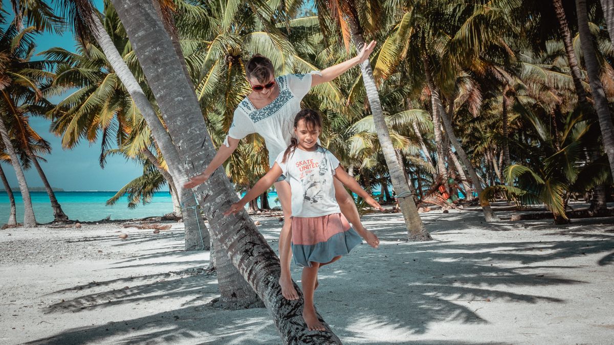 playing with island kids on remote island atoll of palmerson island, cook islands
