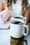 Two mugs of black coffee on a table.