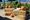 Orange and white pumpkins displayed on hay bales outdoors.