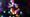 Softly blurred multicolored holiday lights against a dark background.