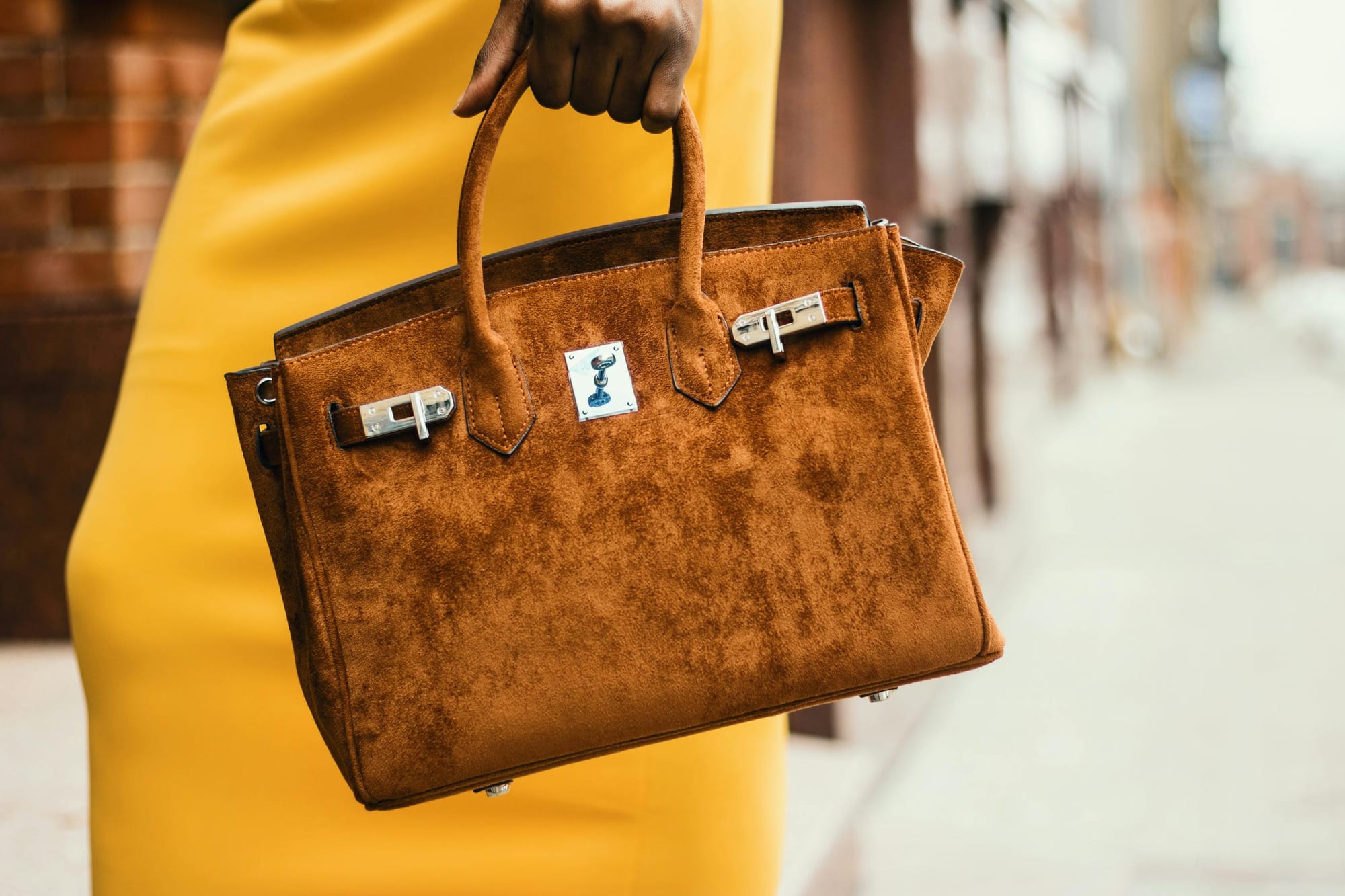 a camel-colored suede handbag