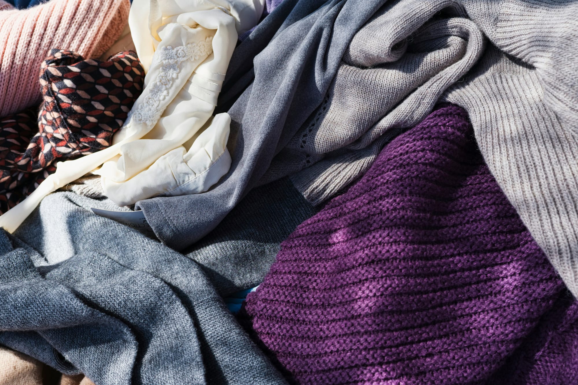An unboxed, unsorted reseller bale of sweaters.