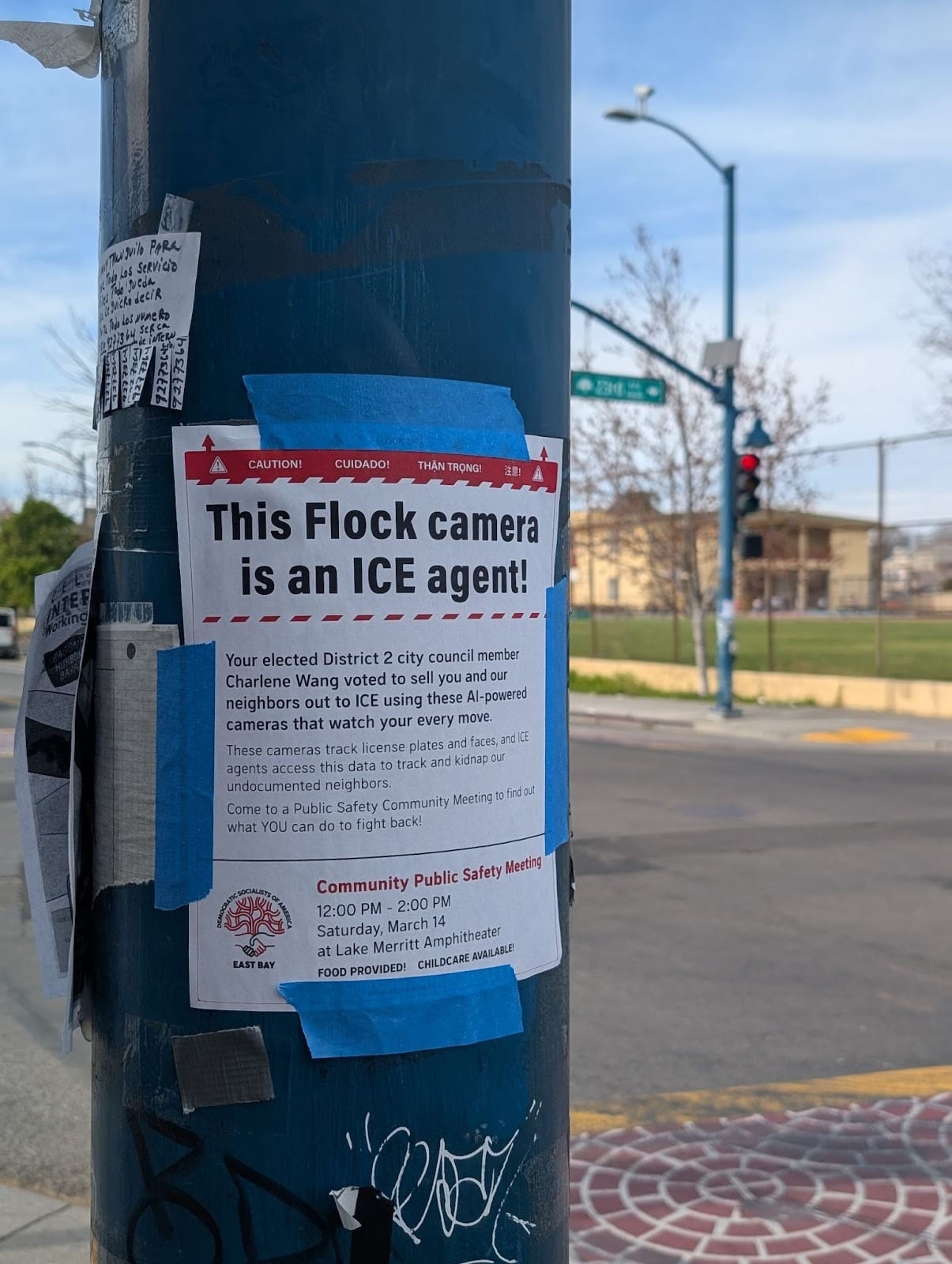"This Flock camera is an ICE agent!" reads this sign, taped up to a pole. The rest of the text goes, "Your elected District 2 city council member Charlene Wang voted to sell you and your neighbors out to ICE using these AI-powered cameras that watch your every move."
