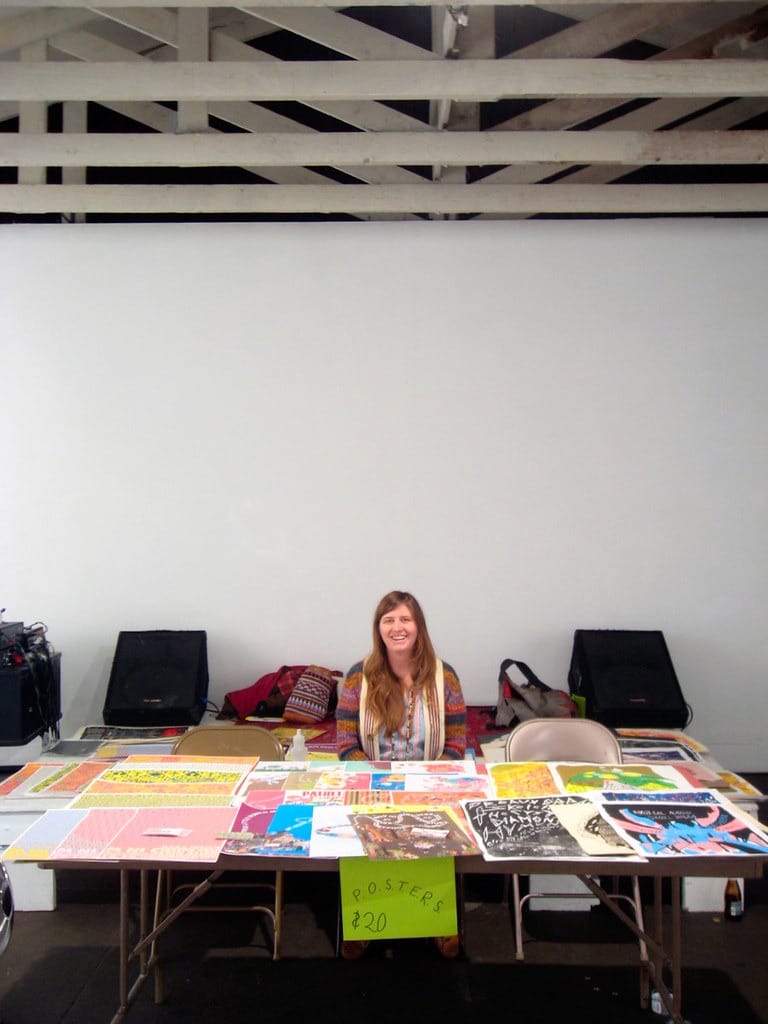 the author selling posters at a table