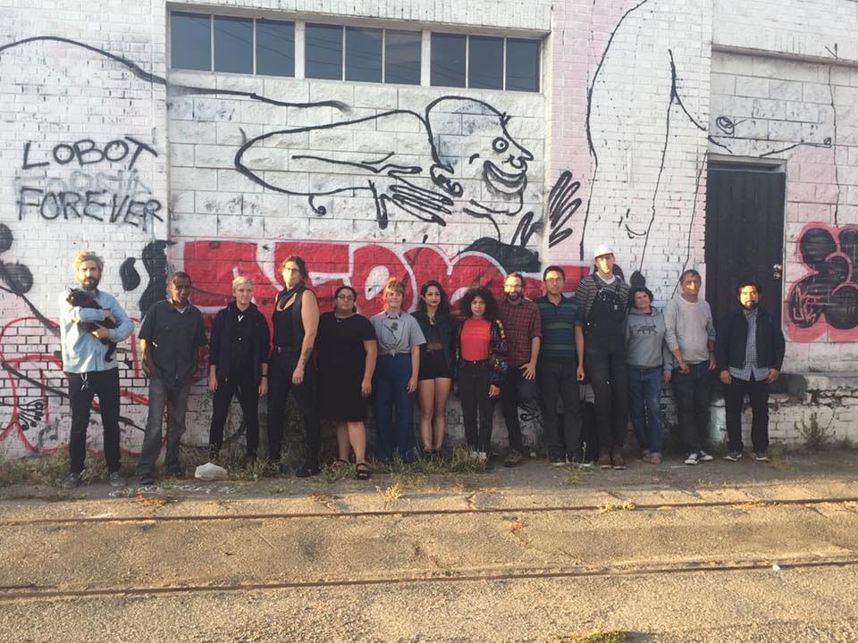 residents posed against a wall