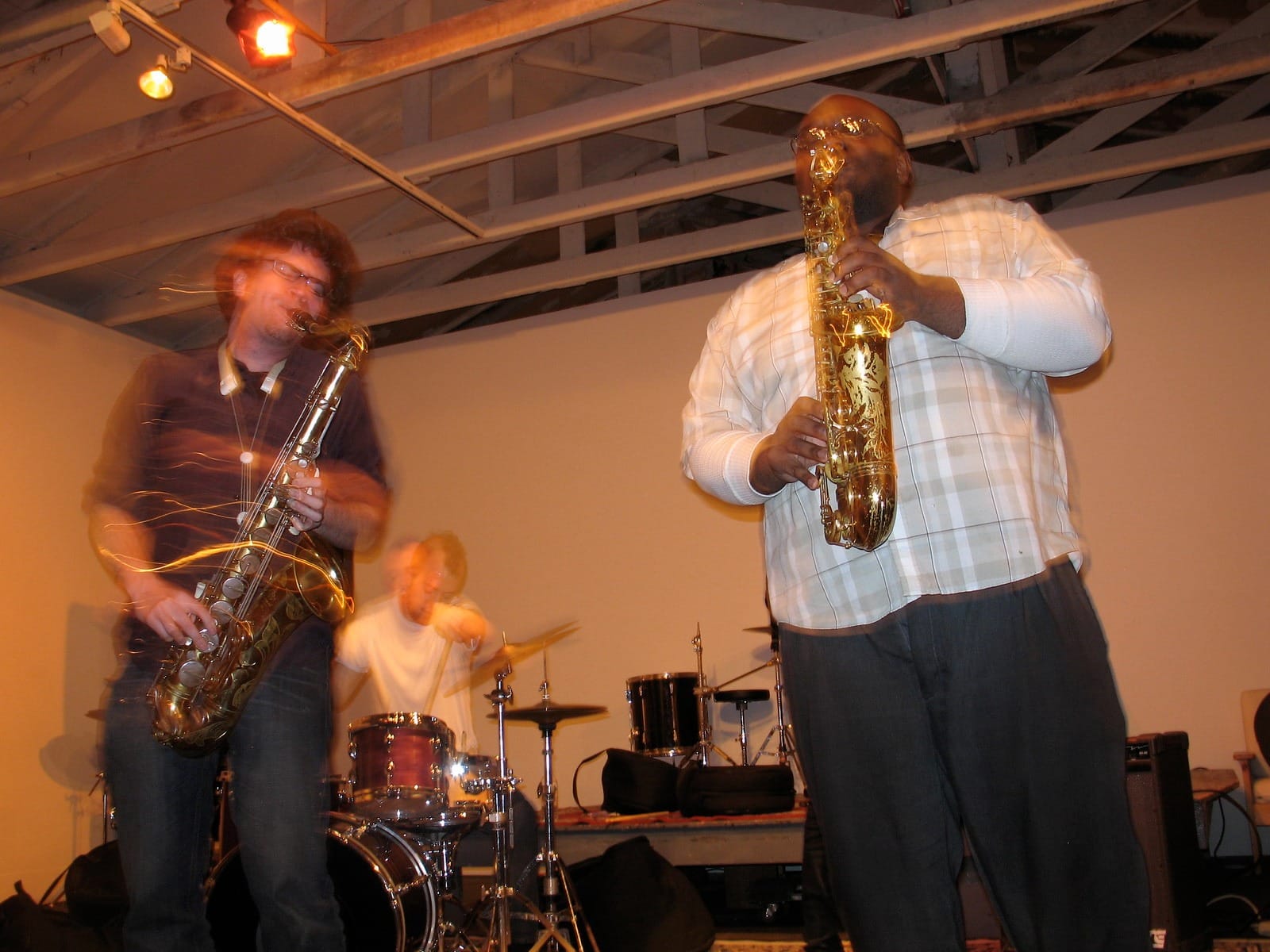 two saxophone players, out of focus