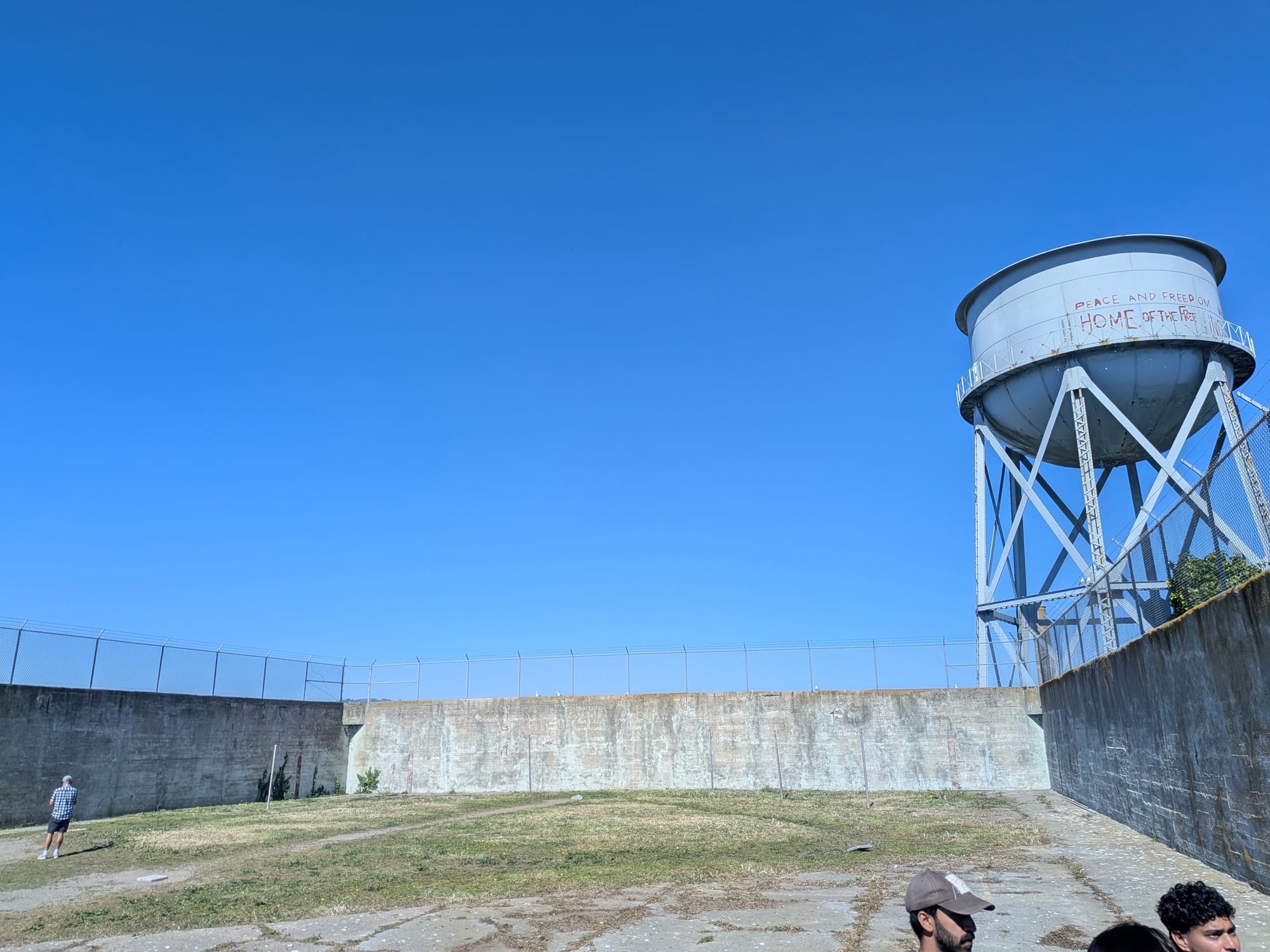 The prison yard, with a blue water tower off to the side.