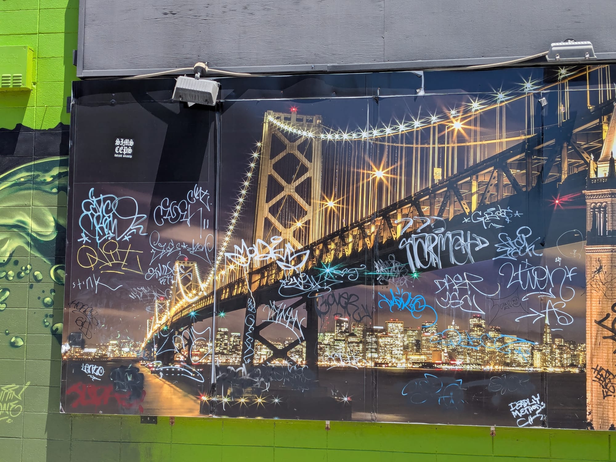 a glittering photo-painting of the bay bridge, just absolutely covered with graffiti tags