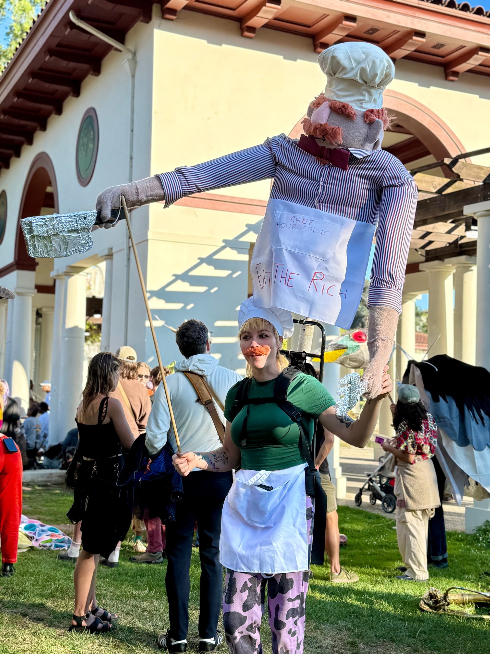 A large puppet labelled Chef Bourgeoise and Eat the Rich, modeled after the muppet Swedish Chef.