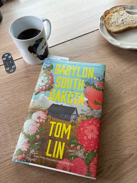 the book on a desk, now, with coffee and toast