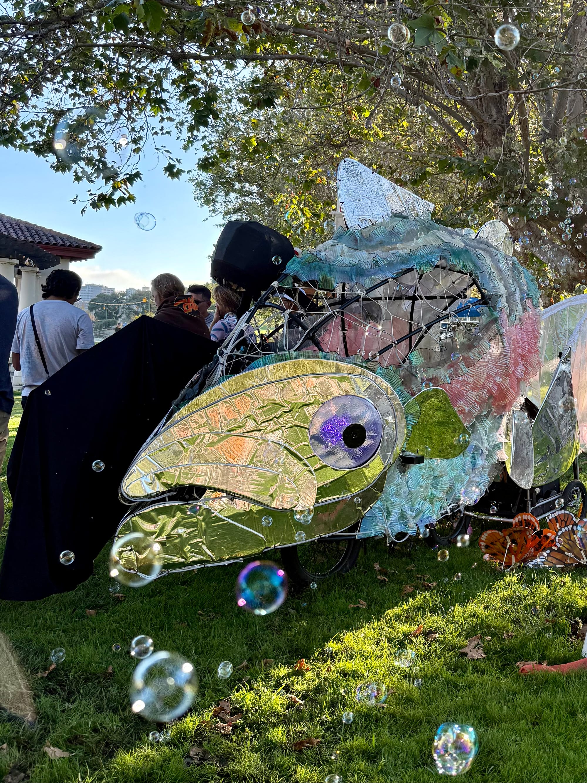 A salmon blowing bubbles puppet sculpture.