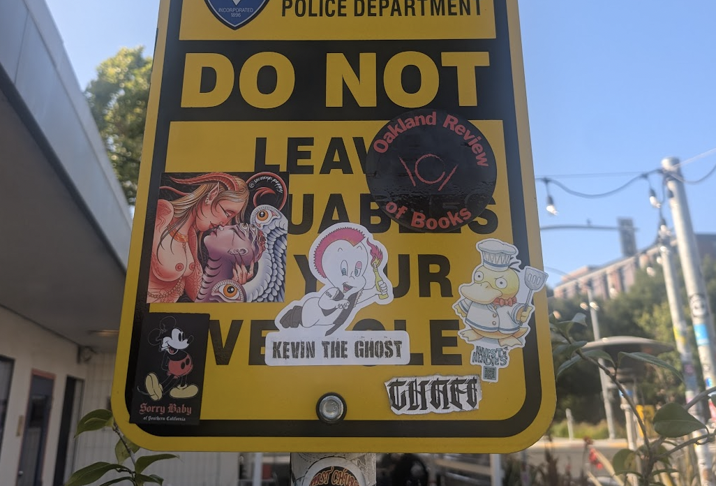 A "do not leave valuables in your vehicle" sign with an ORB sticker among others