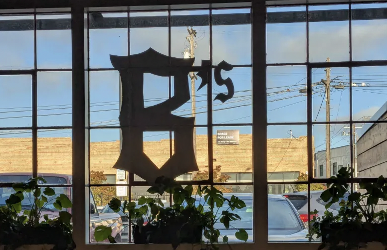 Interior of Prescott Market, looking out through the Ballers sign.