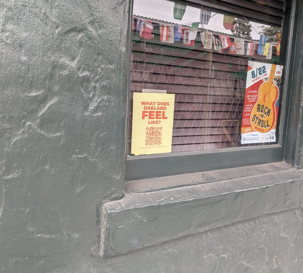 A "What Does Oakland FEEL Like?" sign, in a window.
