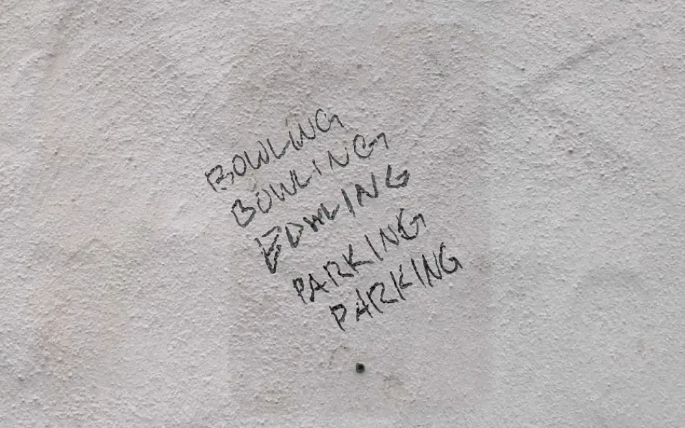 Graffiti reading "Bowling Bowling Bowling Parking Parking"