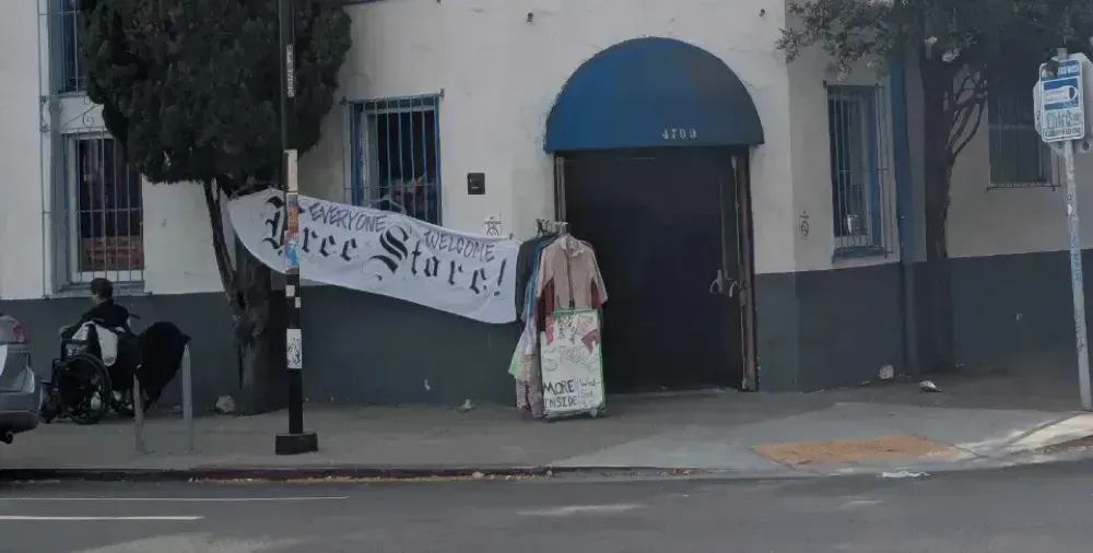 A building with a sign reading "Everyone Welcome, Free Store!"