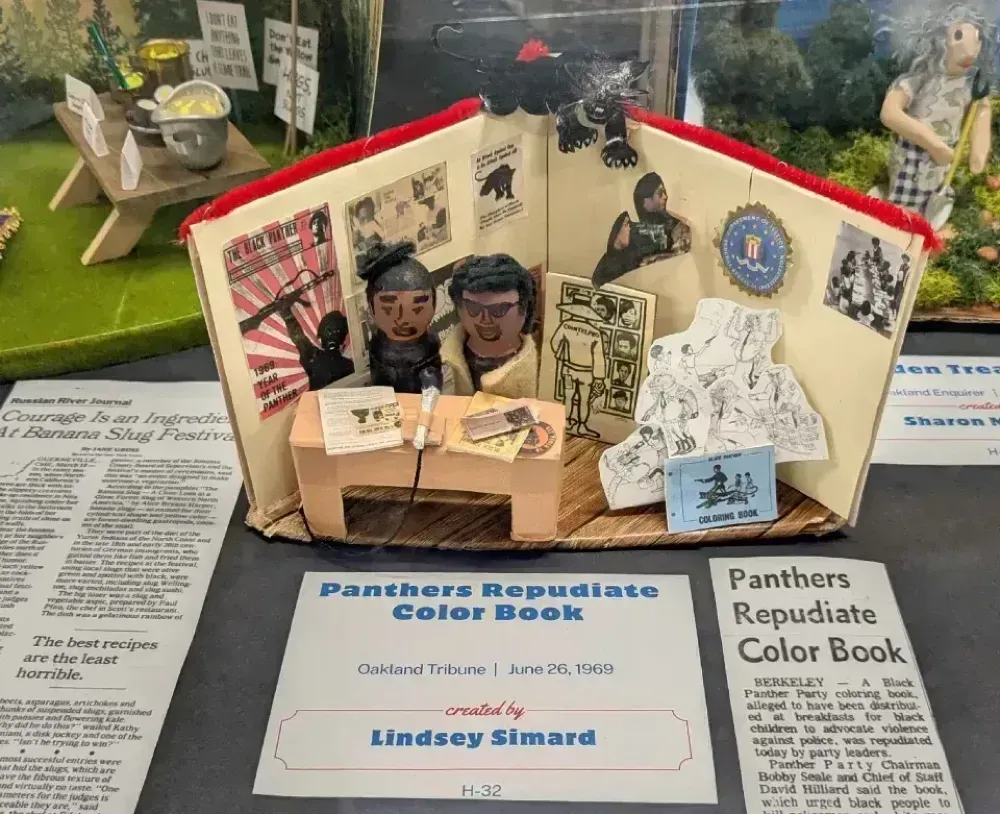 A diorama representing a newspaper story (pictured here): "Panthers repudiate color book"