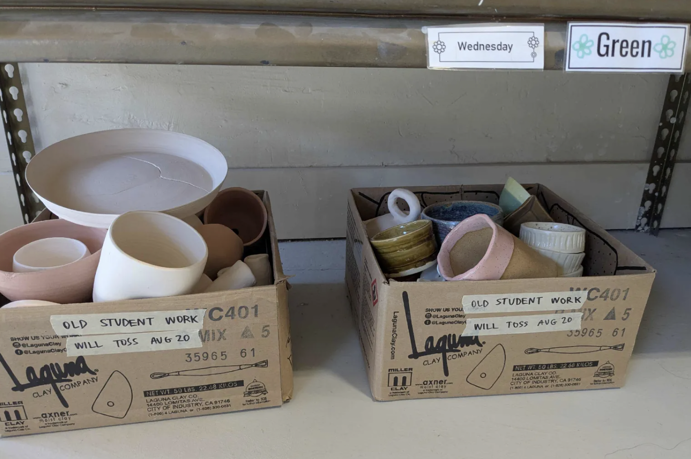 "Old student work; will toss" boxes at a ceramics studio.