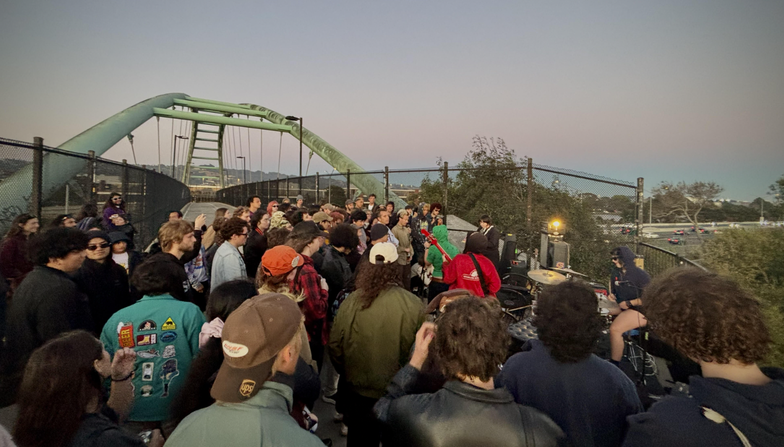 Band playing on the pedestrian bridge as the sun goes down.