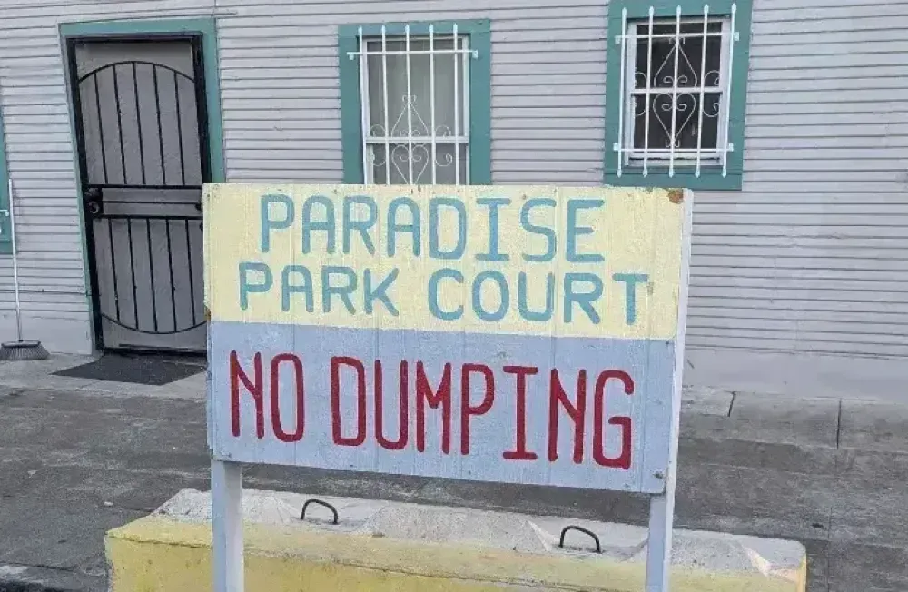 A sign reading "Paradise Park Court" and below it "No dumping"