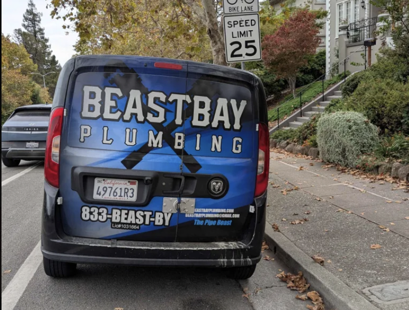 A "Beast Bay Plumbing" truck.