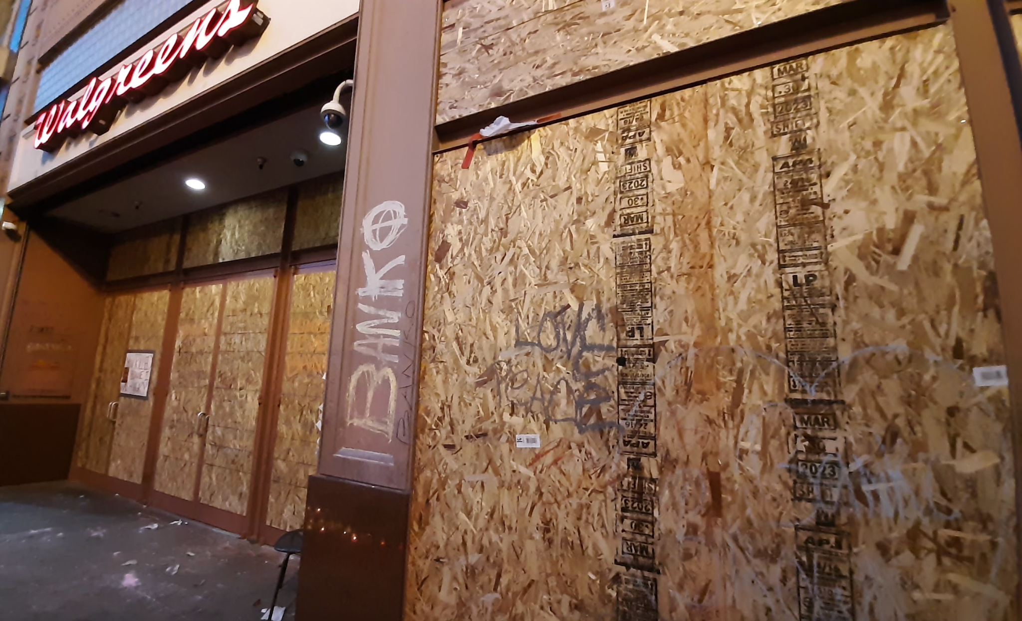 A boarded up Walgreens, with "Banko" graffiti.