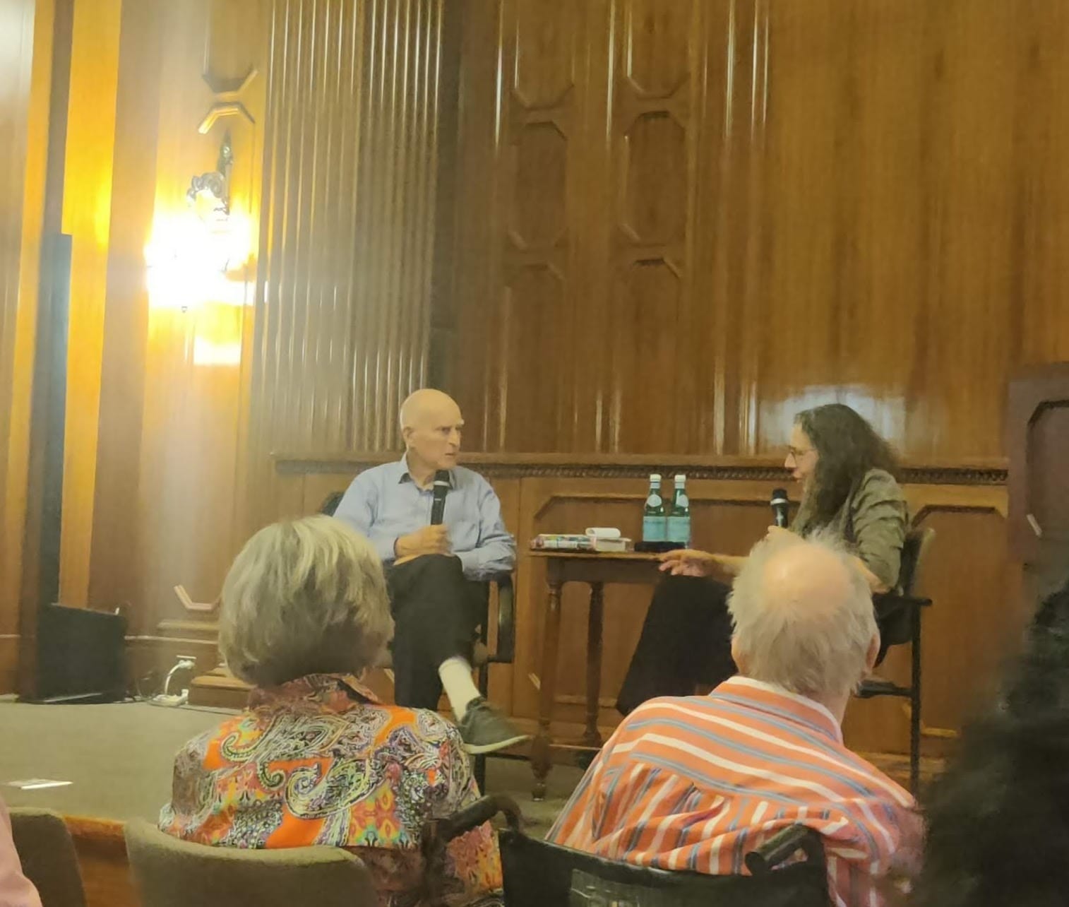 Jerry Brown genially chatting on stage with Miriam Pawel.
