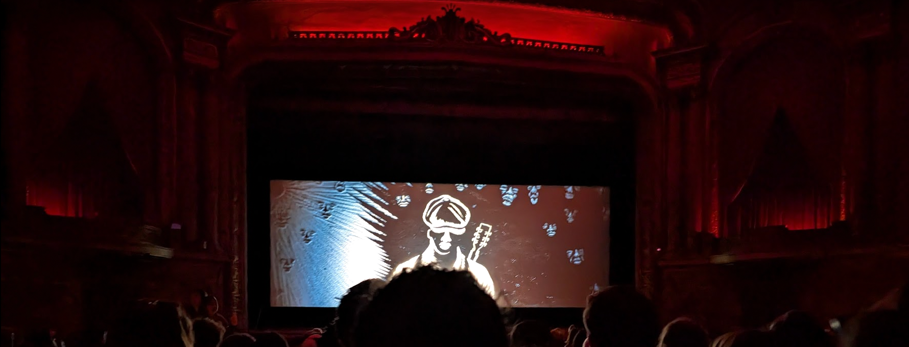 A photo of the movie screen at Grand Lake Theater, on which a scene from "Sinners" is playing.
