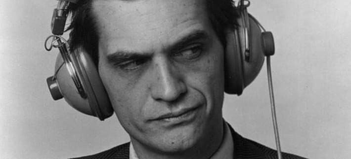 A black-and-white photo of a contemplative Ian Shoales/Merle Kessler, a dissatisfied curl to his lip.