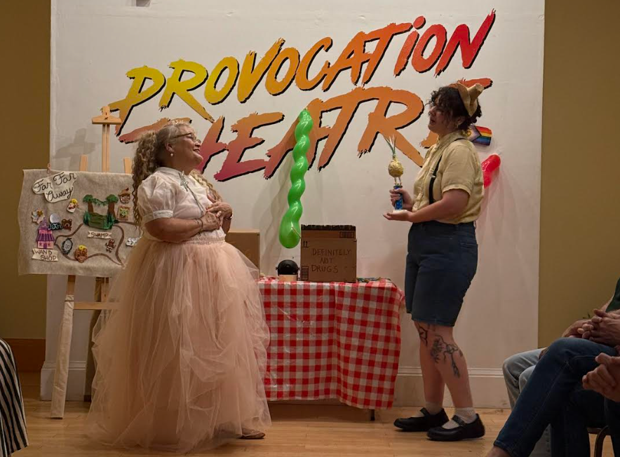 two performers in lavish costumes looking like their having a good itme